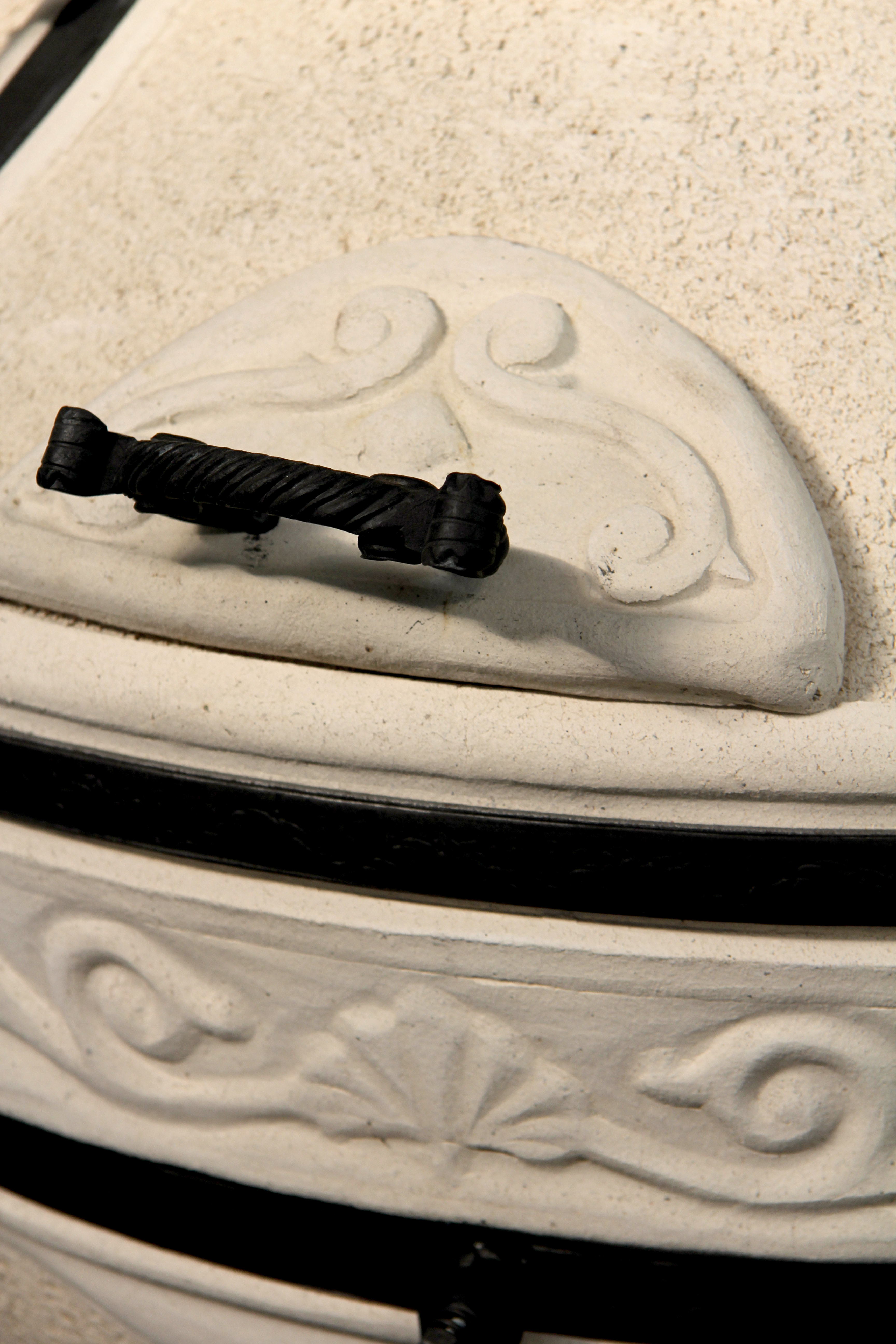 Detailansicht des schwarzen Metallgriffs an der seitlichen Öffnung des Amphora Tandoor Aladdin